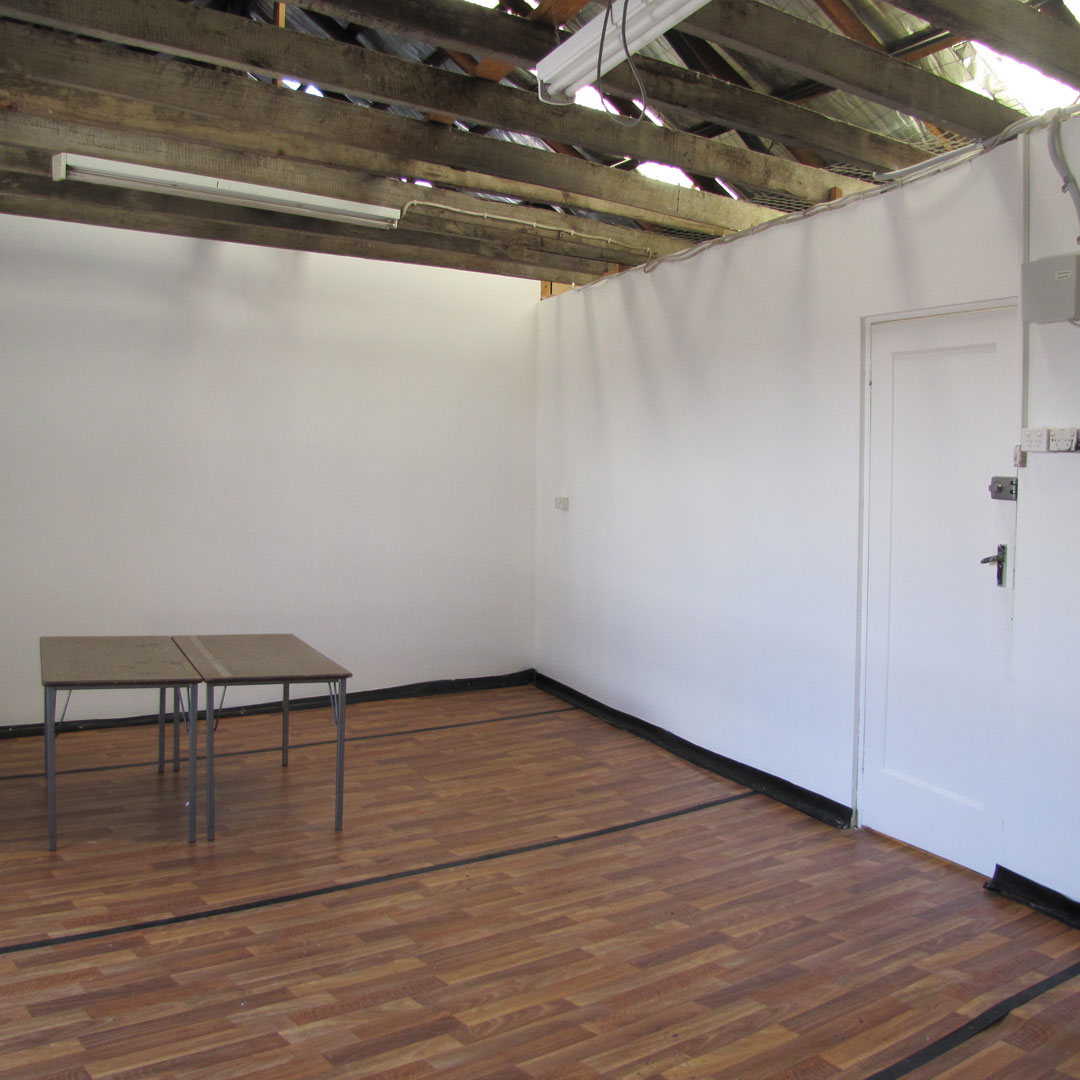 An artist's studio with two tables.