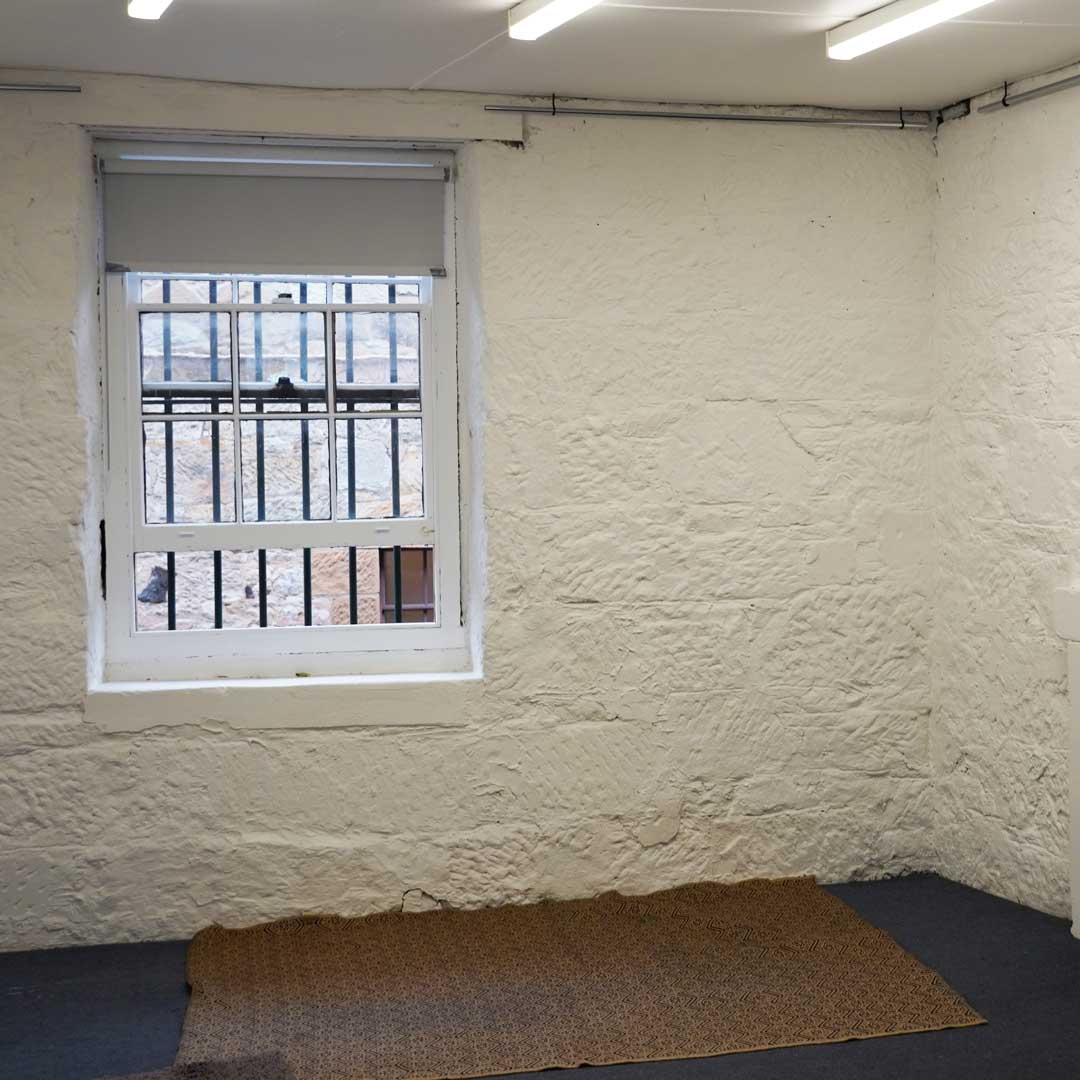 An old stone wall with an old fashioned sash window