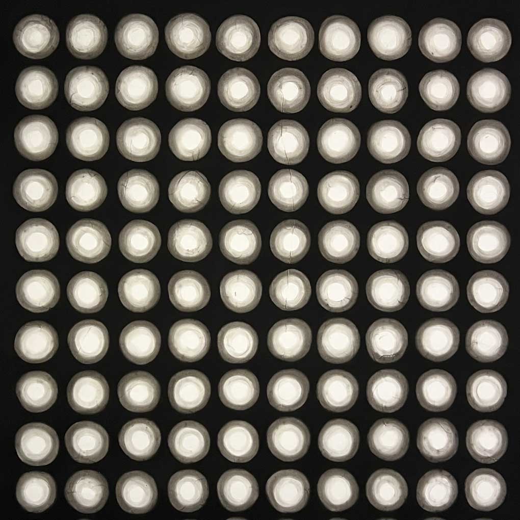 Small white circles in a grid pattern, against a black background.