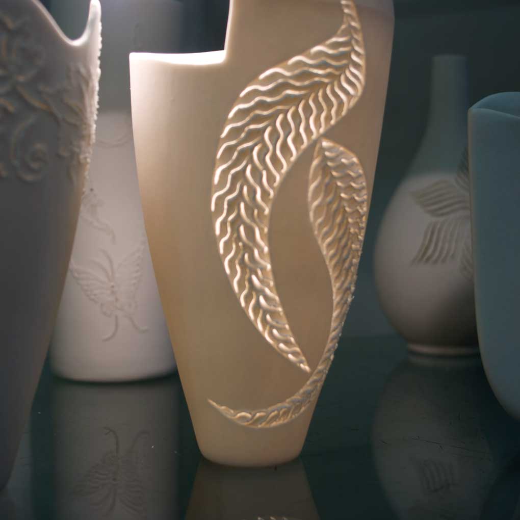 Several porcelain vases illuminated from the inside.