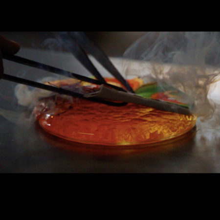 A close up of molten orange glass in a circular form.