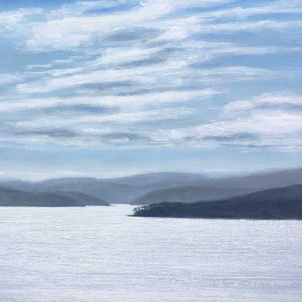 A painting of a river, with sun reflecting on the water. IN the distance there are rolling mountains that get lighter as they are further away.The blue sky is filled with clouds.