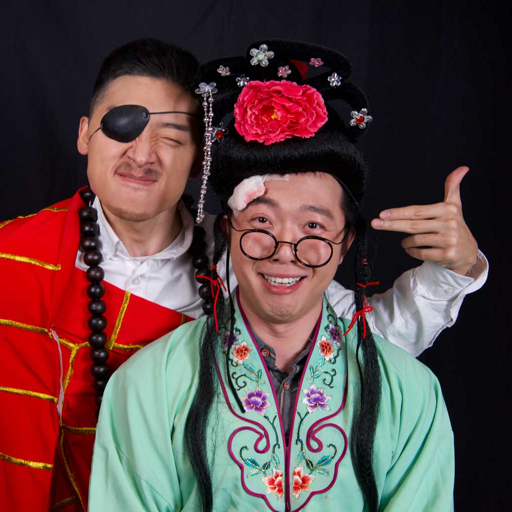 Two actors in theatrical, traditional Chinese costume.