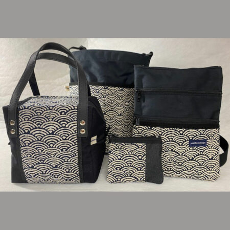 An assortment of bags made in various navy coloured fabric