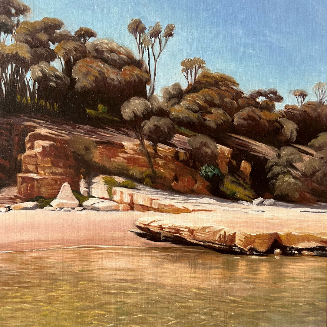 A painting of a shoreline. In the foreground is shallow water and a sandy beach, with large slabs of limestone forming the bank. On the bank is growing bushy trees and shrubs.
