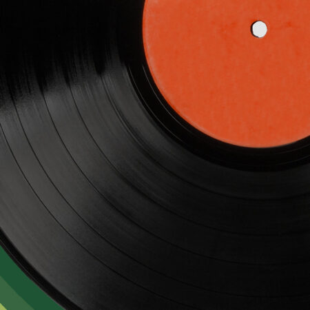 A close up image of a record with an orange inner.