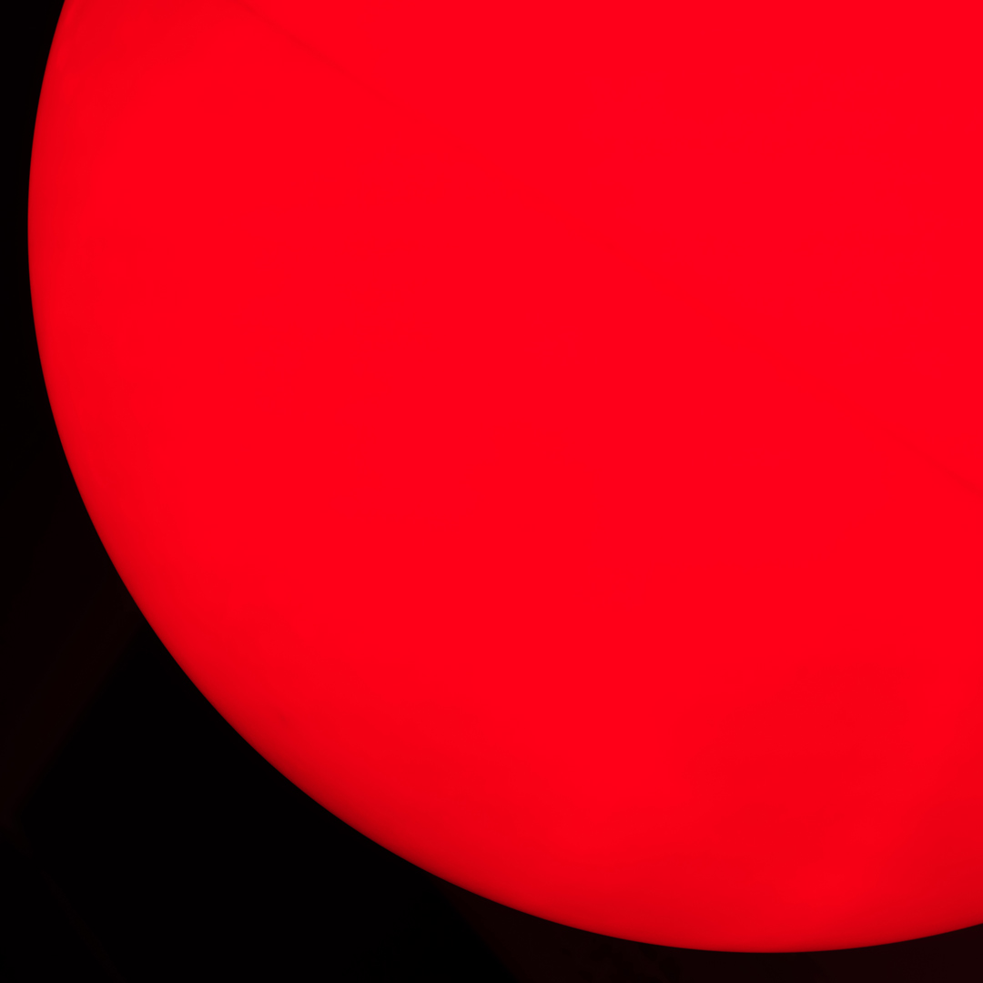 A bright red circle against a black background.
